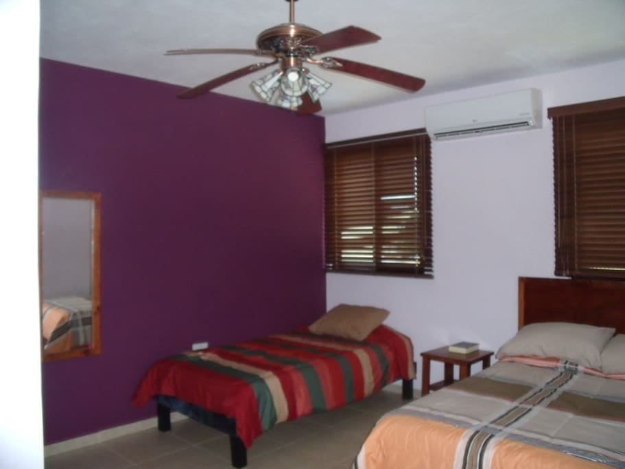 Clean room with air conditioner and ceiling fan.