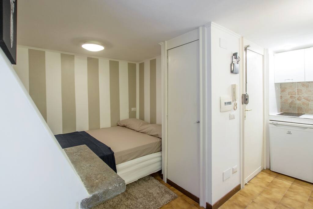 The wardrobe is next the bed