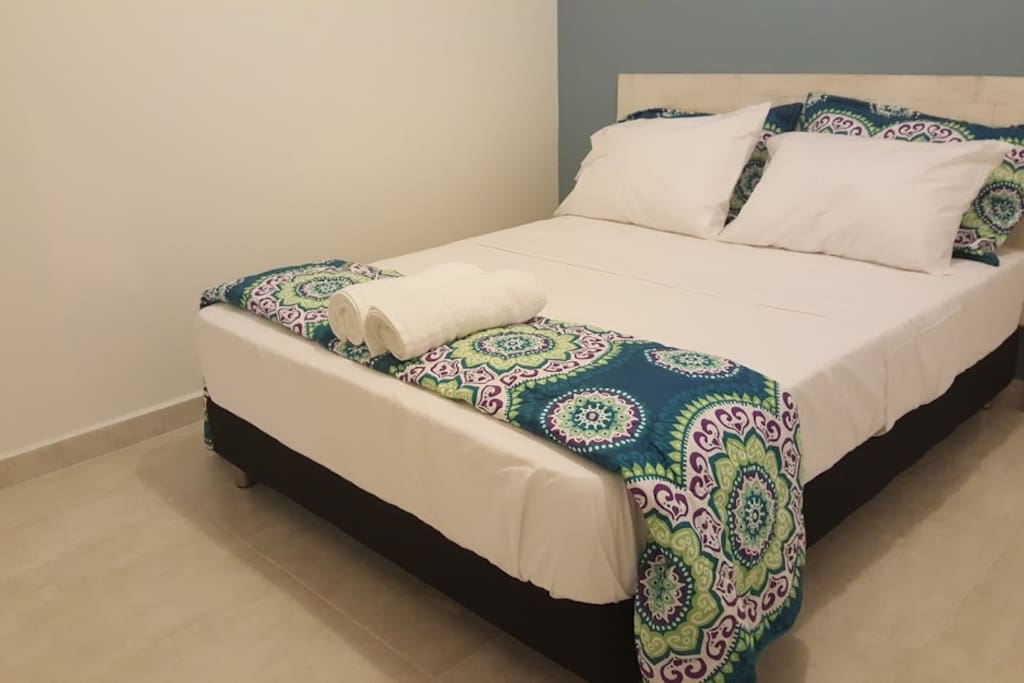 Each private room features a large, comfortable bed.