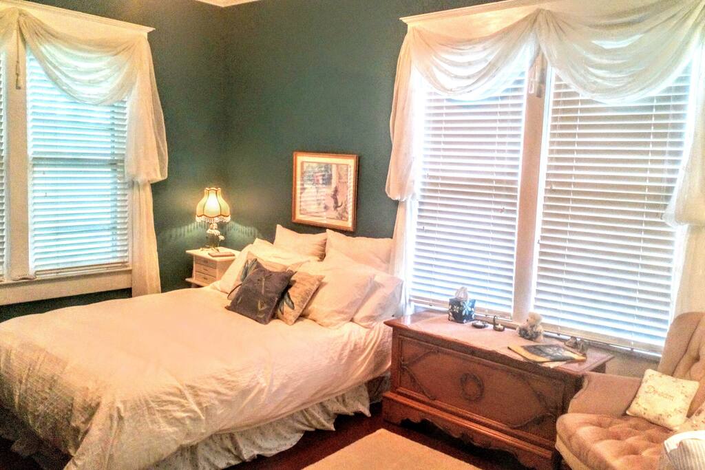 Large queen bedroom with closet, dresser, and work space.