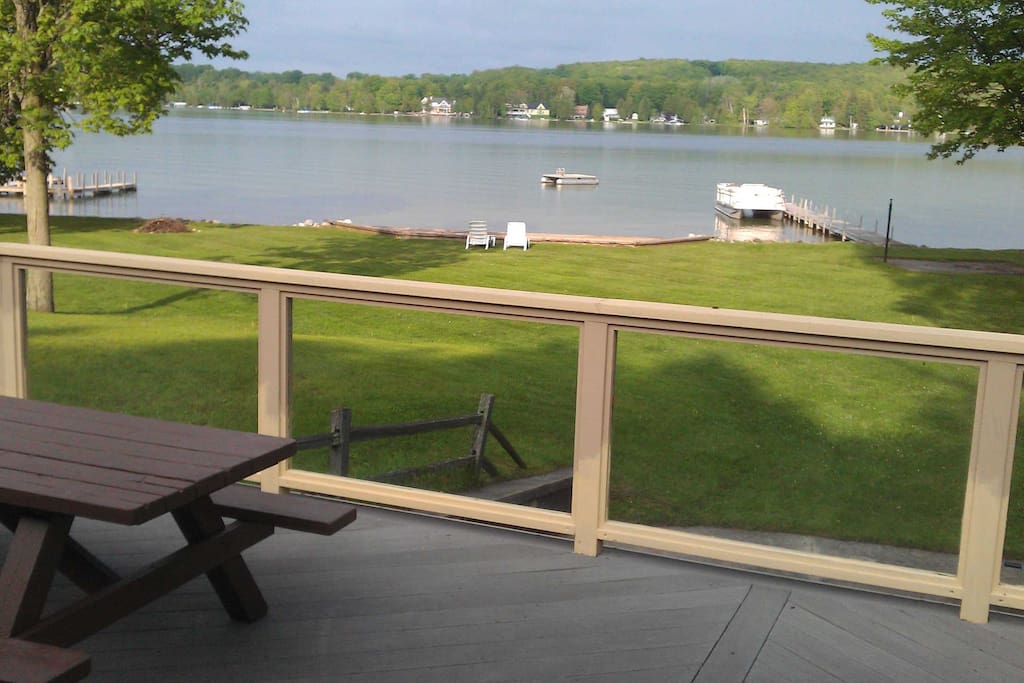 View of lake from deck with glass railings