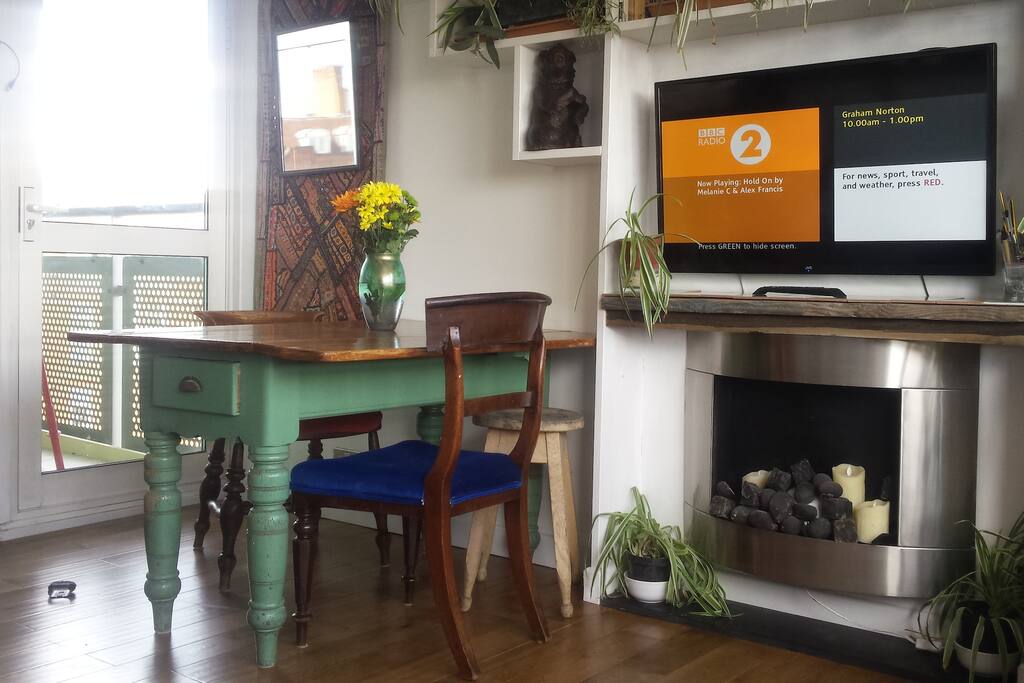 Big TV, dining area and feature modern fireplace