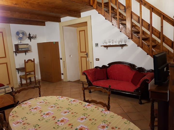 Downstairs: left side, entrance door is between the wardrobe and the sofa.