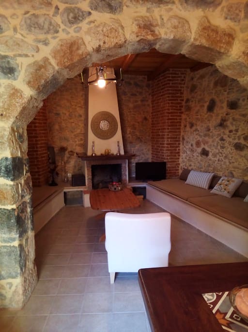 The living room with the two built-in couches and the traditional fireplace