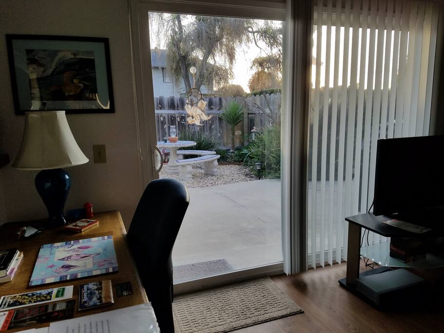 Looking out from living room to side yard patio area. Early risers can catch some beautiful sunrises while waking up with coffee or tea or...