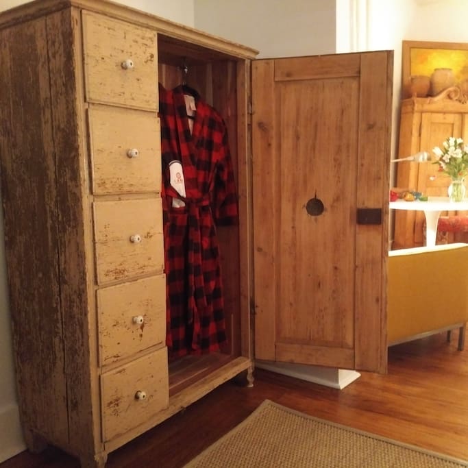 Refurbished pantry cupboard, lined with cedar, with winter flannel robes, and hangers.