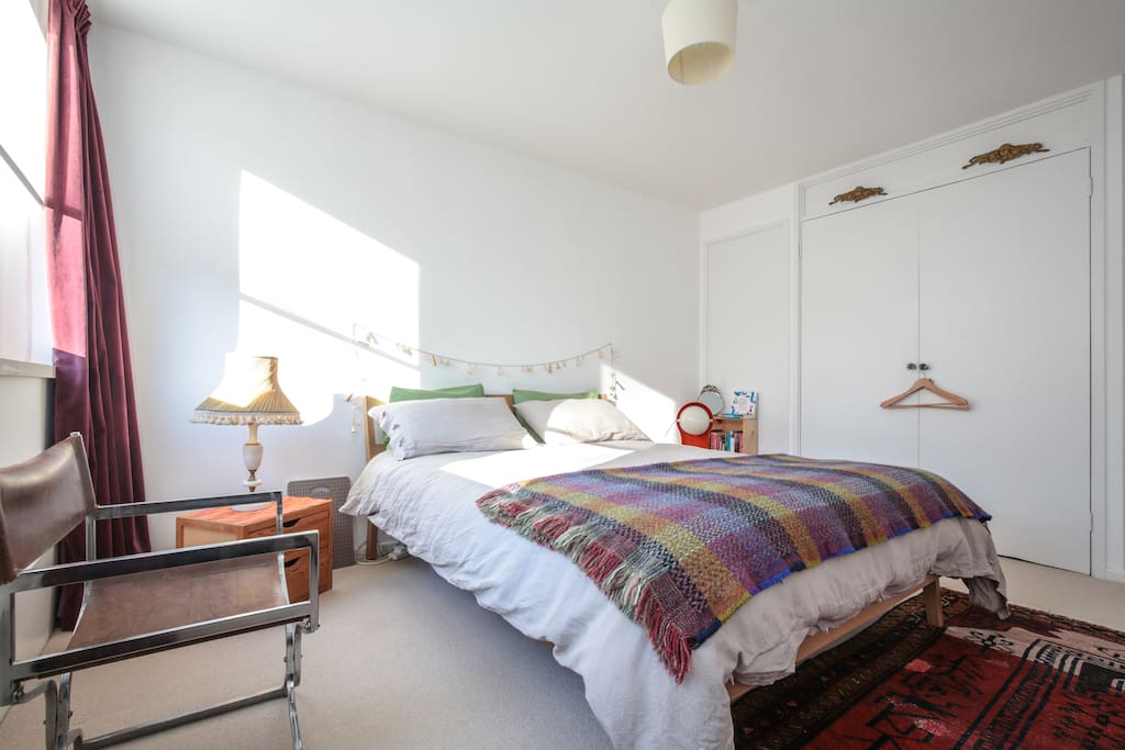 Airy and light bedroom with king bed. Notice the wardrobe is not available, but 2 chairs, bedside tables with drawers are, 5 hooks & hangers. The door has a lock.