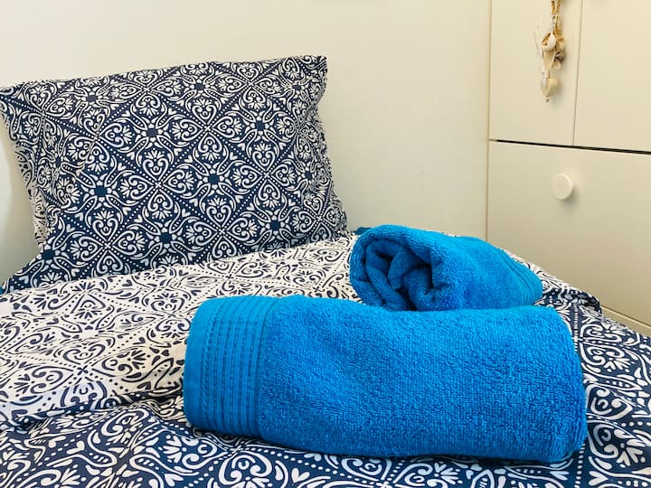 You sleep in a double bed of 140/190. 
Sheets  and towels are provided.