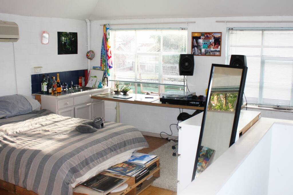 Bedroom upstairs with sink, desk and storage