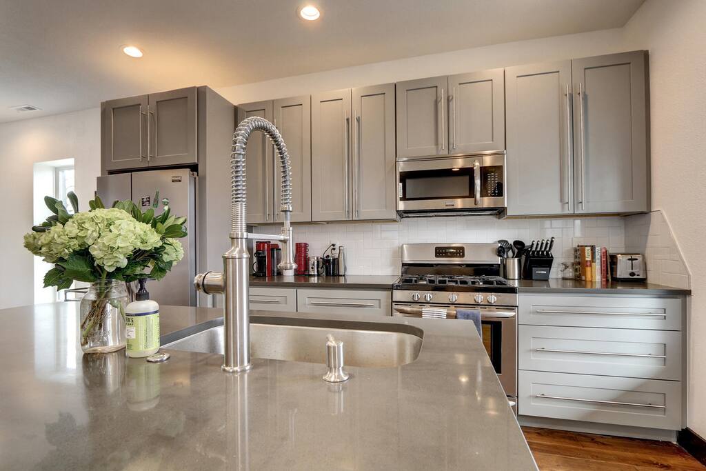Kitchen features a gas stove, toaster, microwave, Nespresso and drip coffee makers.