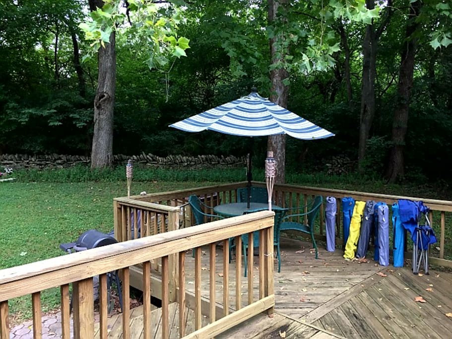 Large Deck with Umbrella and Lots of Folding Chairs