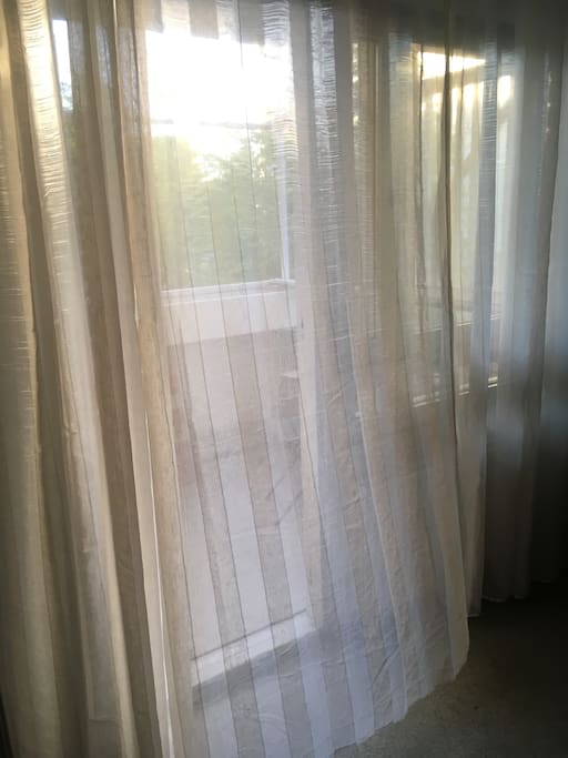 Balcony. There are blinds between the curtains and windows that blocks the light.