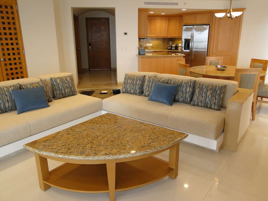 Spacious open concept living room, with open floor plan to kitchen , dining area. Large flat screen TV, stereo surround sound. Room has floor to ceiling glass doors that open out to patio with private hot tub.