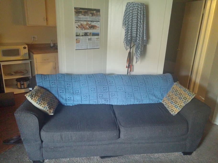 This is the most comfortable couch in the world. I often sleep on this couch when I am staying at the apartment, and I am 6 foot 4. this would be a great place for additional guests to sleep in as well. hint: take the back cushions off for even more room and you can even use them as giant pillows or leg rests.