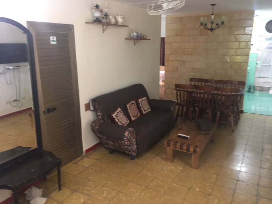 Sala comedor de 18.00m. Dos sillones, sofá, mesas de centro, mesa de comedor de madera de 6 sillas, Smart TV, DVD, espejo grande. Amplia e iluminada.