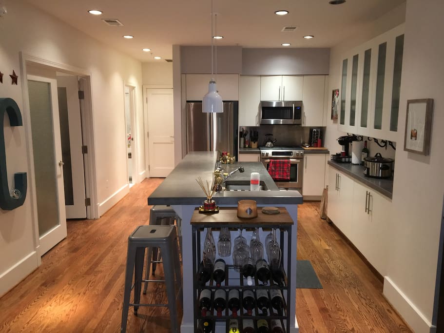 Kitchen w/ high end stainless appliances and 4 barstools