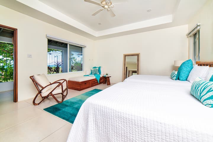 Bedroom #4      16x18 feet
Two Double beds and a sofa bed, en suite bathroom, a/c, ceiling fan, garden, pool, and turquoise Caribbean Sea views