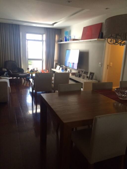 Dining and living room with a giant TV