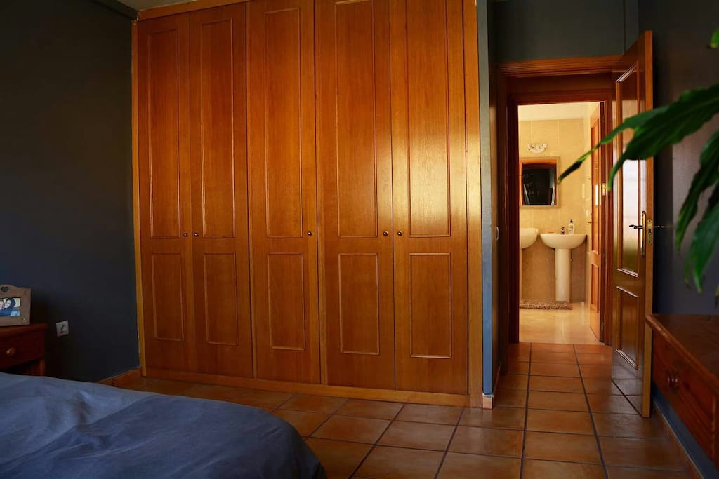 The room has a big wardrobe. Front of the room there is the bathroom.
