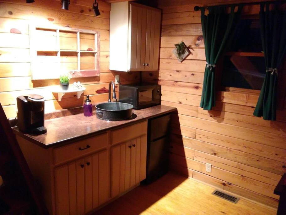 Kitchenette with microwave, Keurig coffee maker, toaster and dorm sized fridge/freezer.