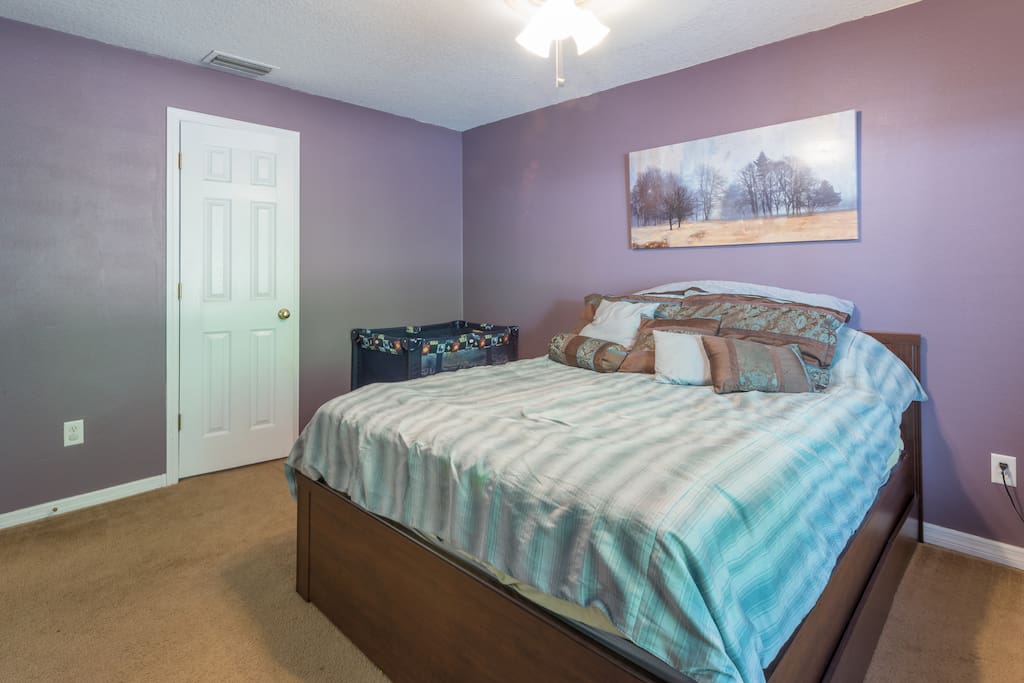 Master bedroom, queen bed, master bathroom door.