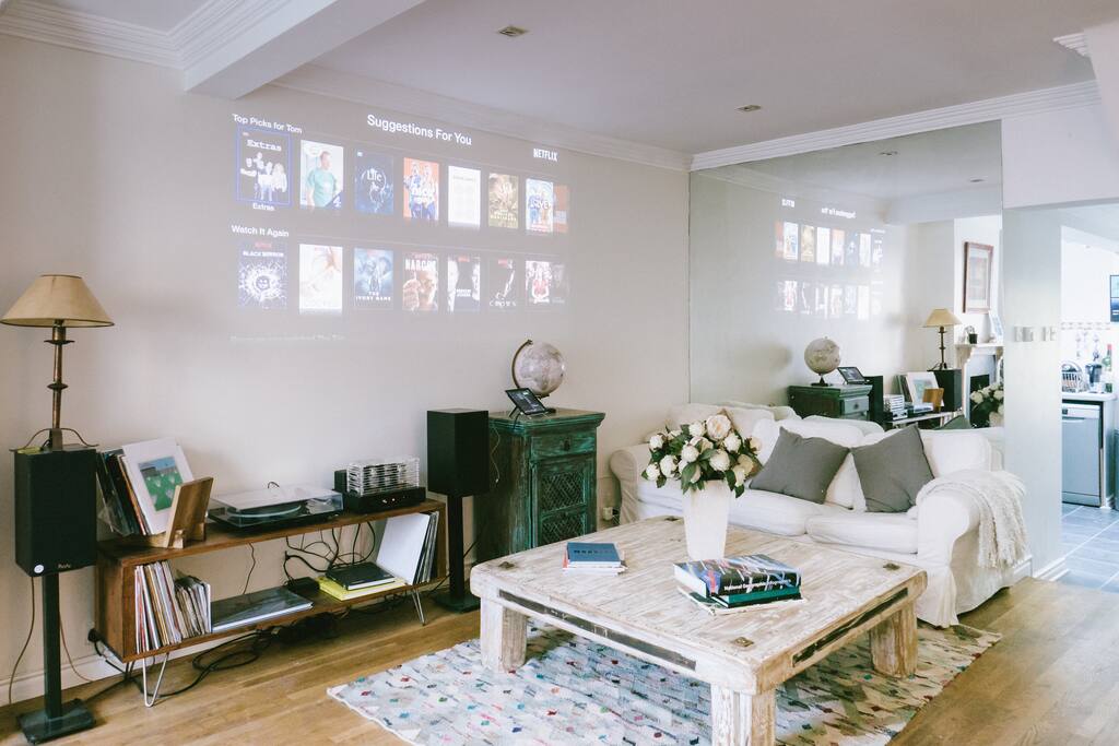 Living room with projector featuring Netflix, Apple TV