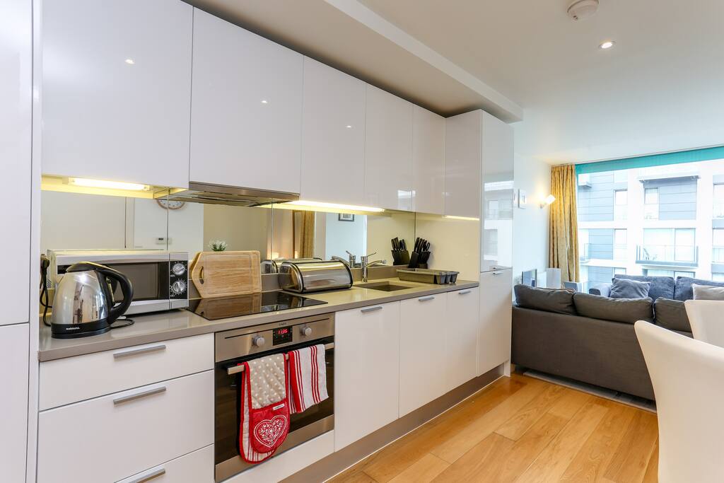 Fully equipped kitchen with utensils, cooking dishes, crockery and cutlery (and a pint of milk).