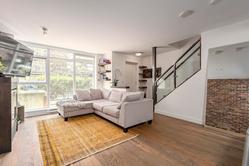 Living room area with remote roller blinds.
