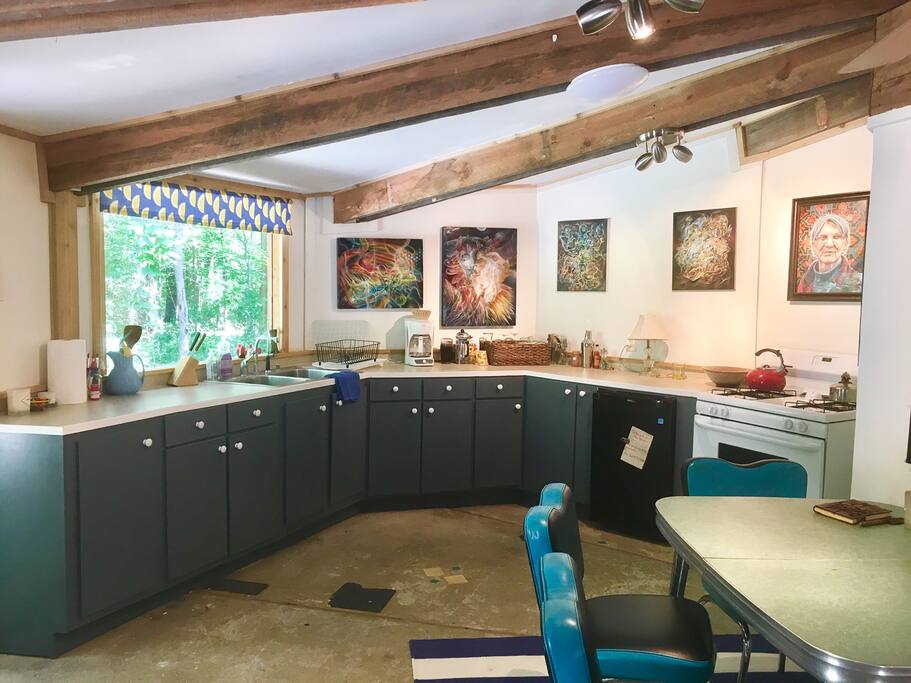 Kitchen is roomy. Has 2 coffee makers, drip and french press. Small Fridge, Full stove. A few pots and pans.