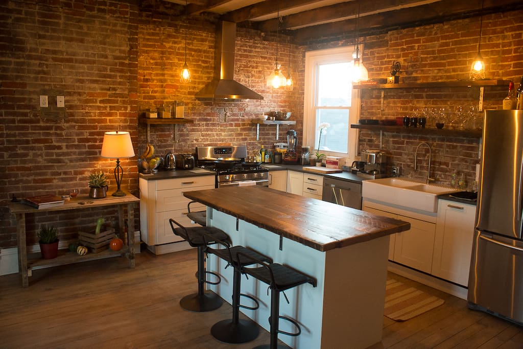 Fully furnished kitchen has all stainless steel appliances including fridge, dishwasher, gas stove, and microwave. Includes an espresso machine!