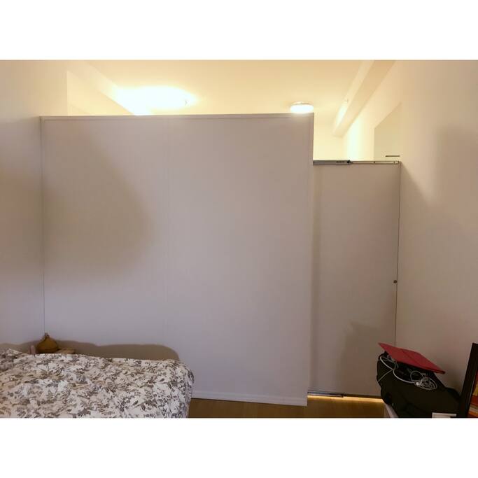 the partition separates the room with the kitchen