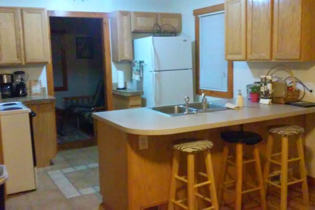 Large kitchen with a great assortment of cooking supplies.
