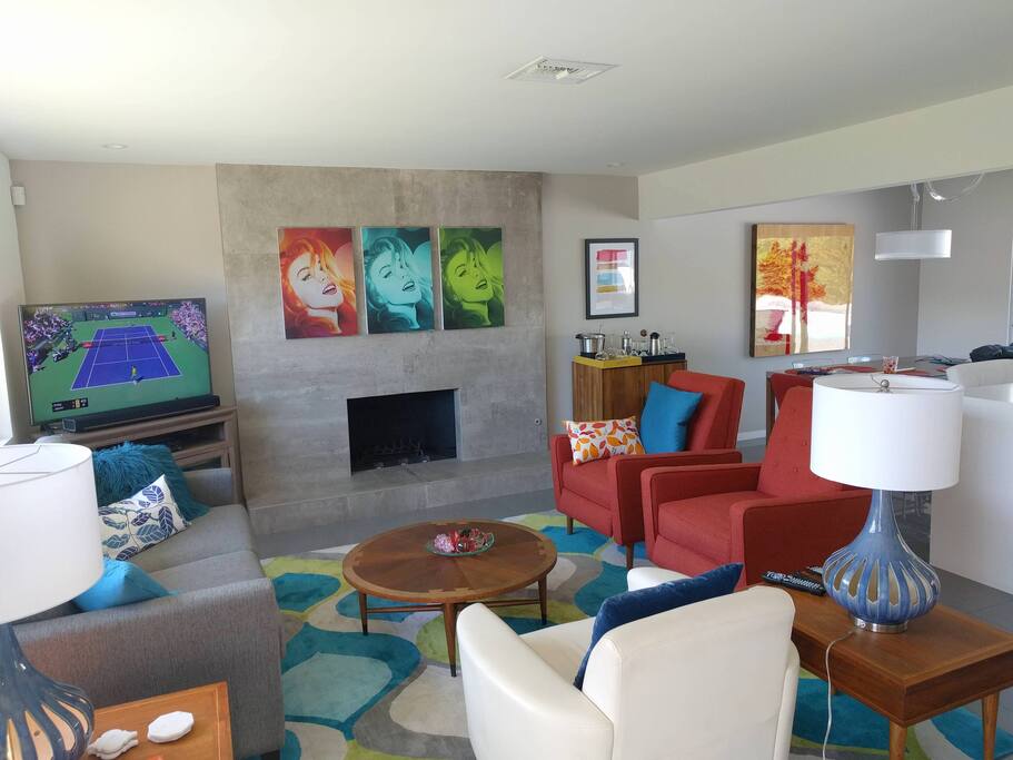 The living area of the open floor plan living / dining / kitchen is bright, colorful, and comfortable.