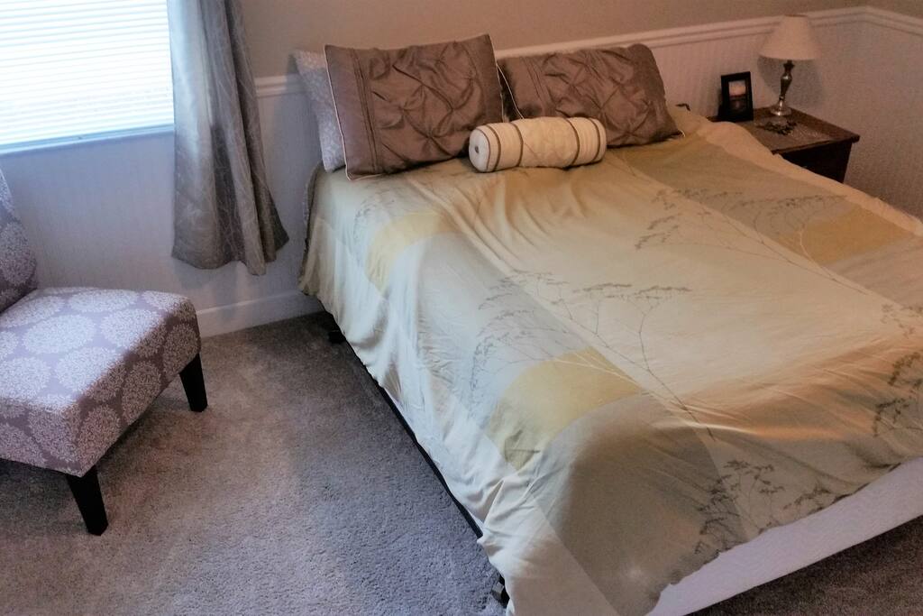 Quest room with Pillow top Queen bed, ceiling fan/light, nightstand, chair, 6 drawer dresser and closet.