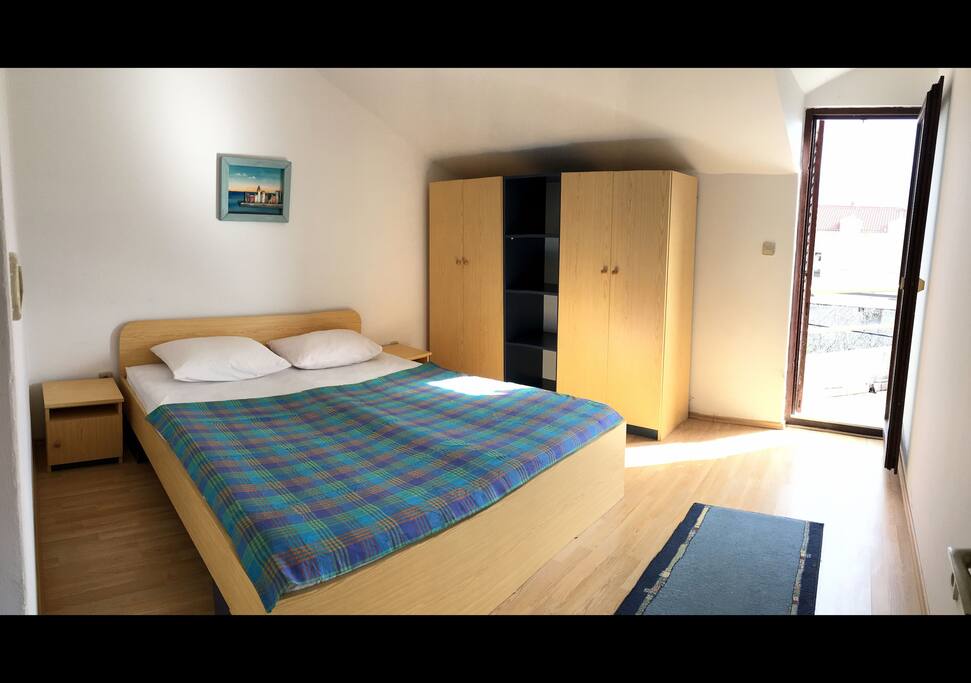 Bedroom with small balcony.