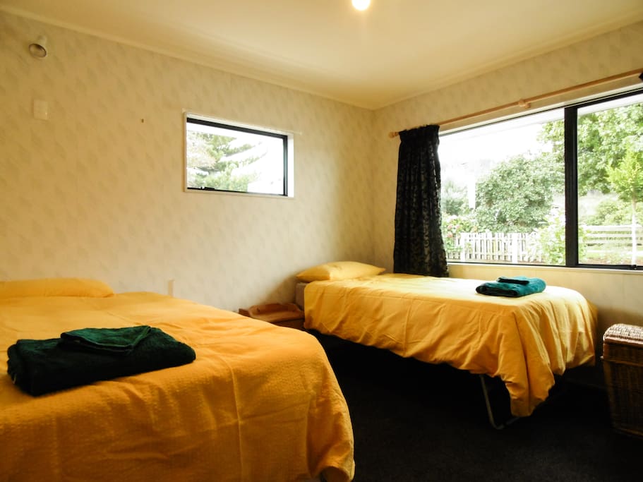 Bedroom with 2 single beds which can join together to make a queen bed.