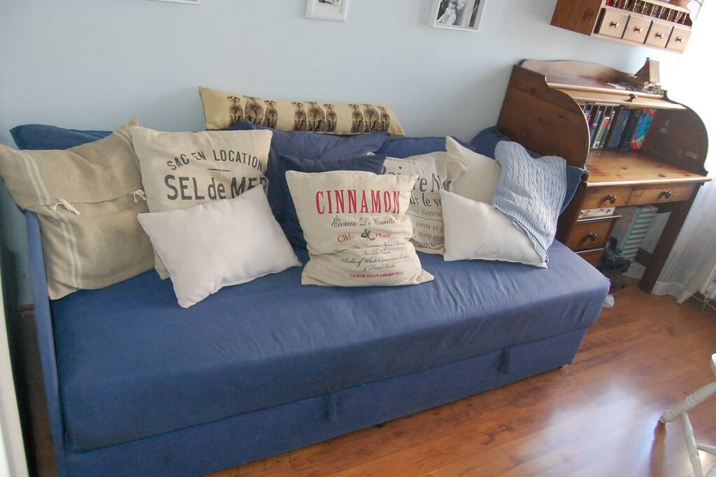 Cushions on the bed turn it into a sitting area during the day.
