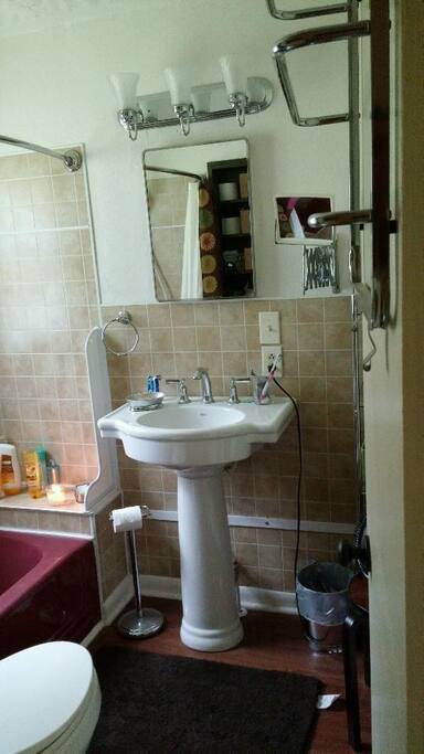 Bathroom with tub with shower.