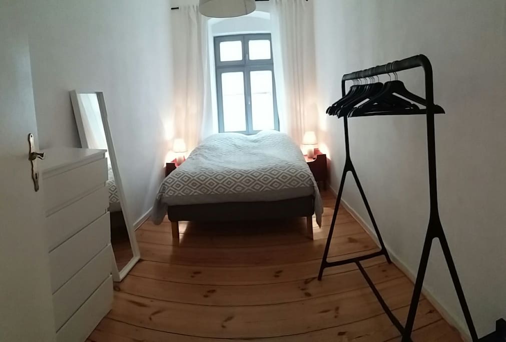 Bedroom with double bed, two hangers, a draw and a shelve