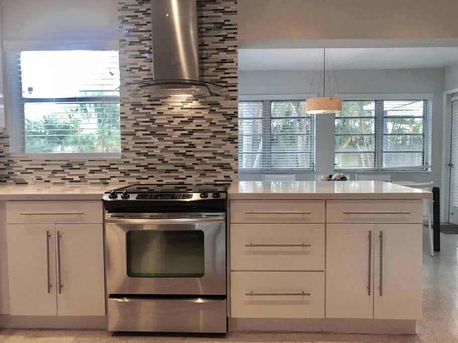 Kitchen and dining area overlooking yard and pool.