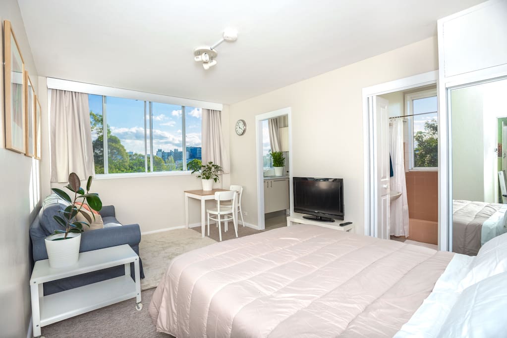 The main space has a two seater couch, a very comfortable queen size bed, a TV, a dining table and more importantly great sunset views!