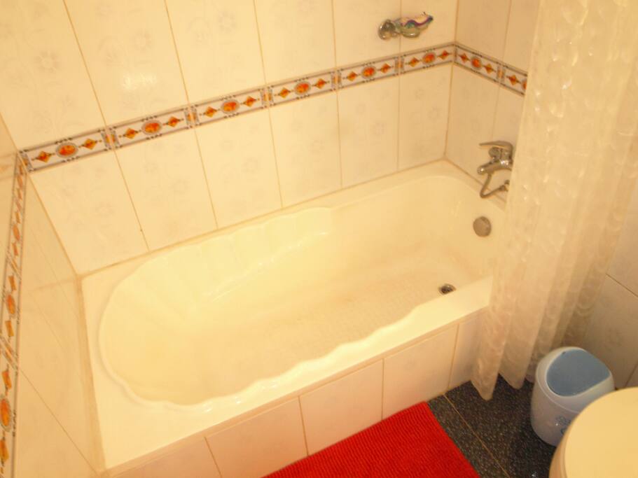 Beautiful and clean bathroom with tub, hot water both in the tub/shower and sinks.