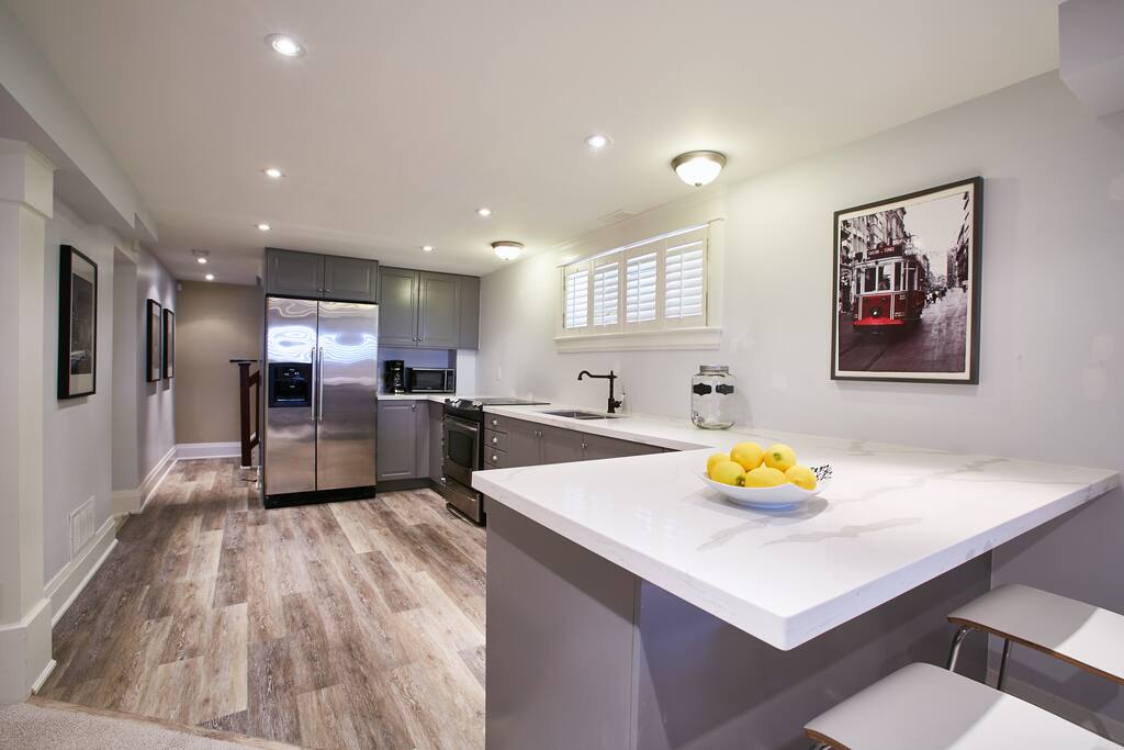 Brand new large kitchen with quartz eat in bar and stainless steel appliances.