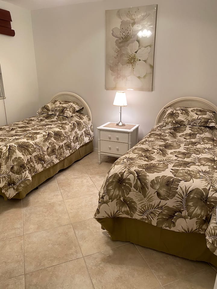 Junior suite complete with two twin beds, a large closet, and a flat screen TV.