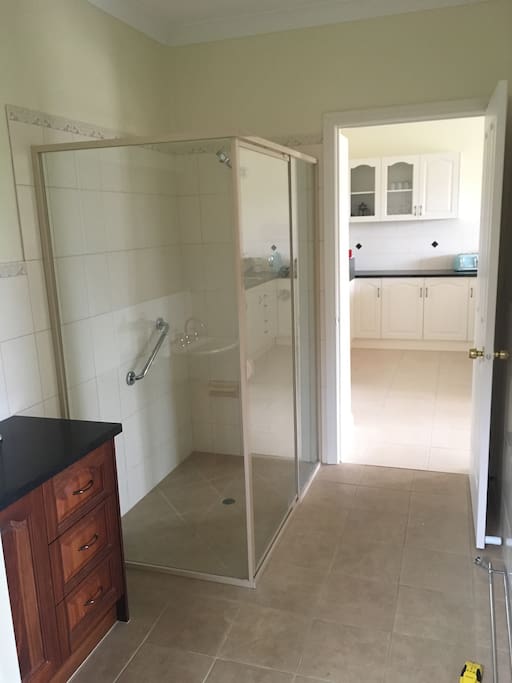 spacious bathroom with shower and separate toilet