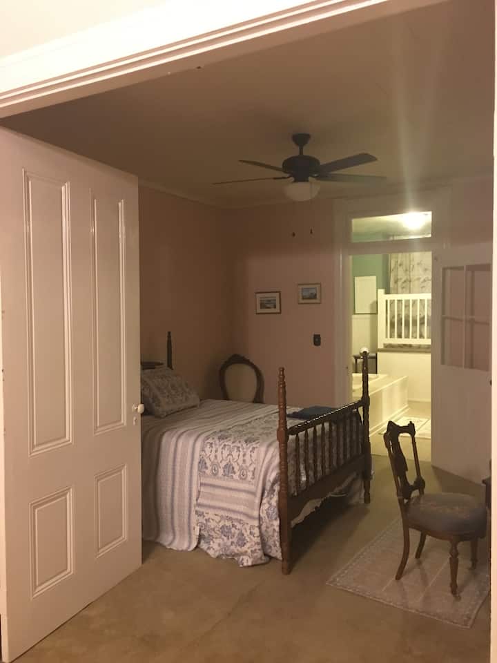 Entry to bedroom from parlor with two beautiful parlor doors.