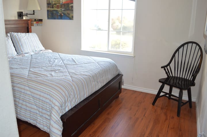 Queen bed in 2nd of 3 bedrooms.