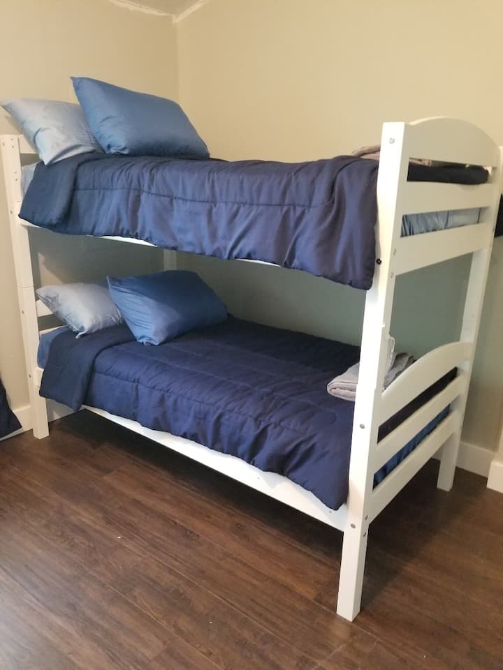 The top bunk has rails and a ladder, they are just not pictured