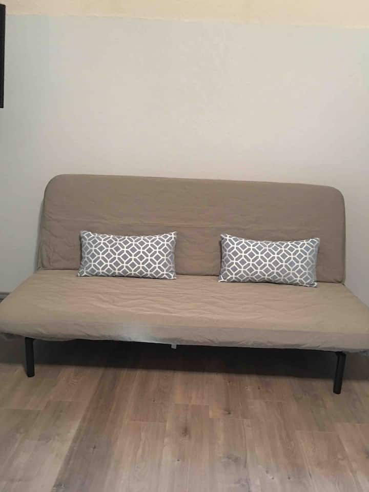 Futon bed the pulls out to a full size bed.  We have bed liens and comforters in the closet 