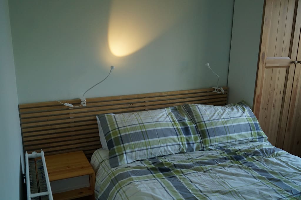 A comfortable double bed in a spacious room.